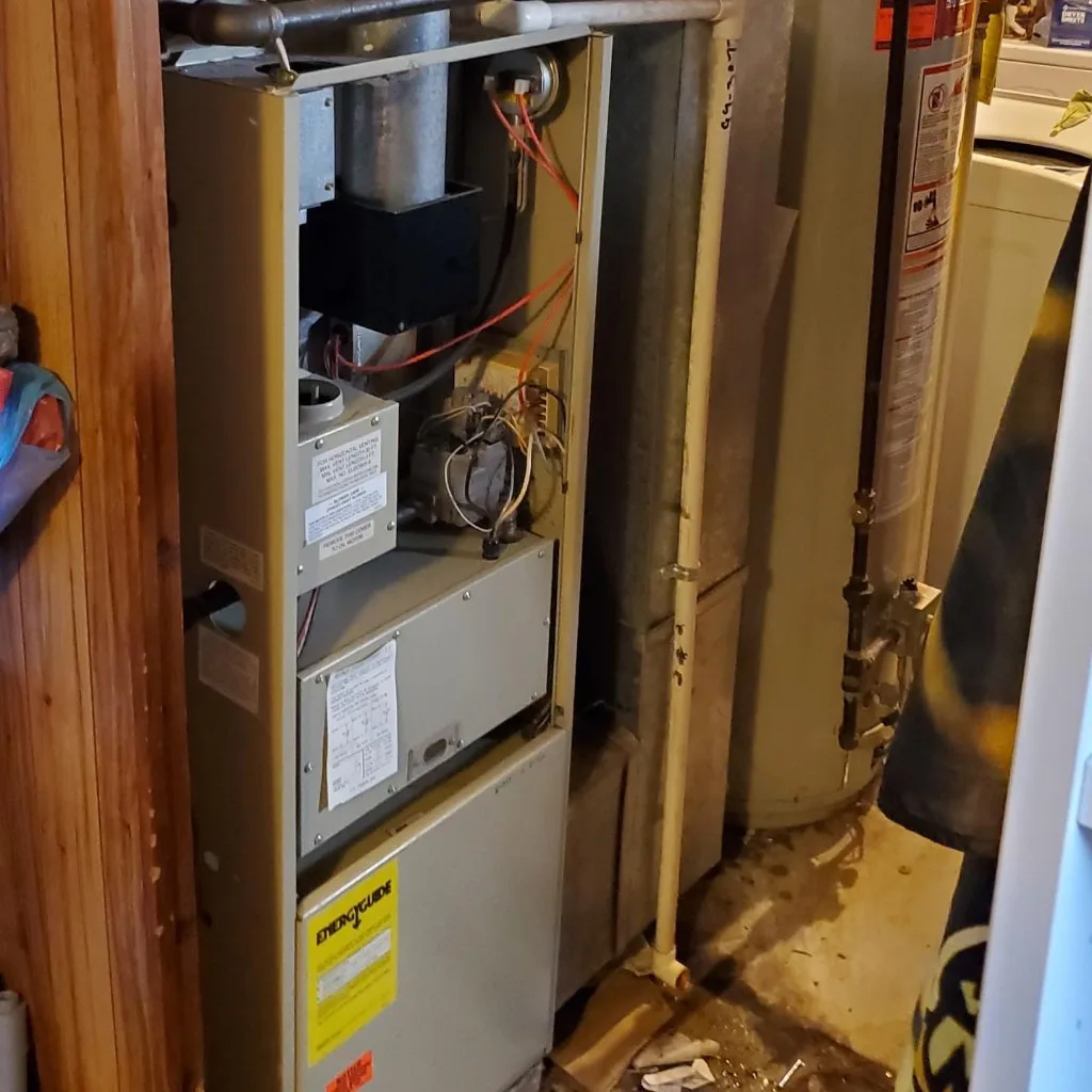 Six Star Heating & Cooling — Before: aging furnace in a tight closet