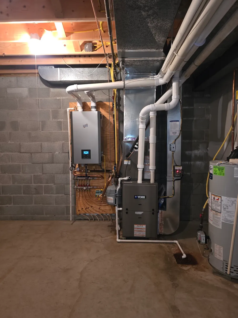 Completed Six Star furnace and tankless water heater installation in a Pittsburgh-area mechanical room.