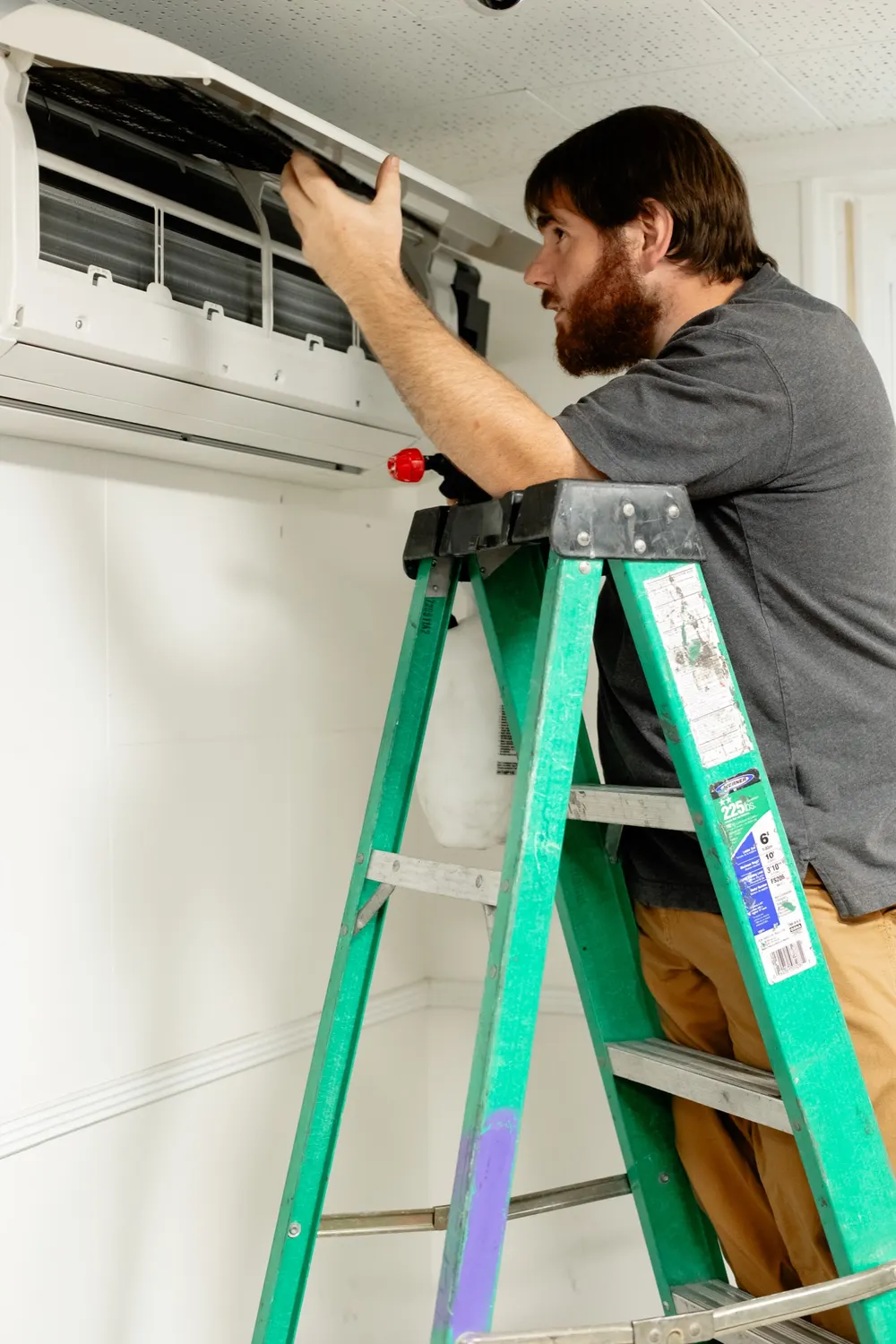 Six Star Heating & Cooling technician servicing a ductless mini-split — Star Maintenance Agreement service in the field.