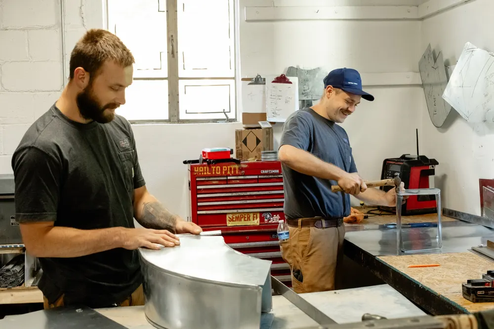 Six Star technicians fabricating custom sheet-metal ductwork in the Carnegie shop.
