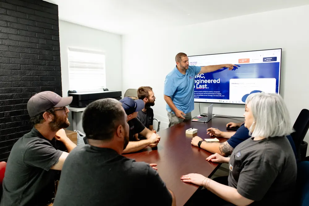 The Six Star Heating & Cooling team in a planning meeting at the Carnegie office.